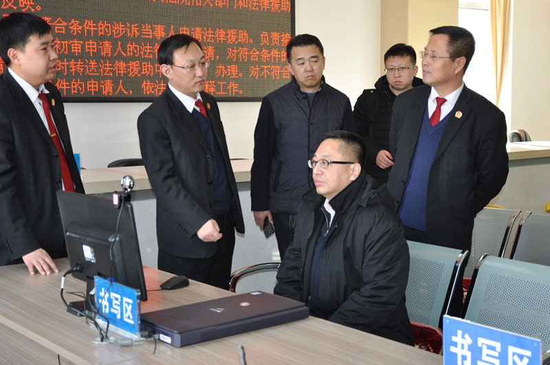 北镇法院党组书记、院长张春风（左二）为前来参观的兄弟法院干警讲解网上立案流程