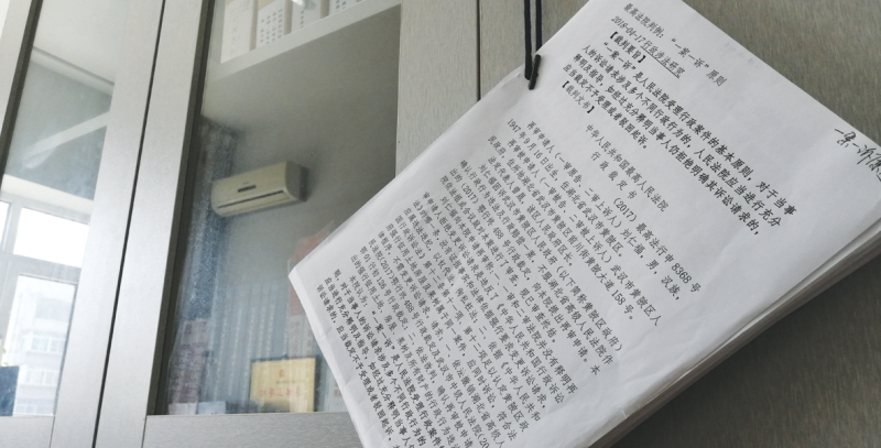 滕启刚书柜把手上挂着的学习材料