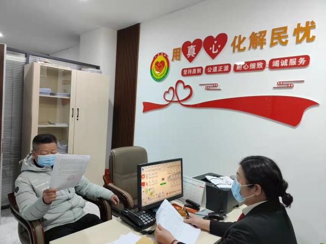 于洪区法院立案庭法官正在对调解协议进行司法确认