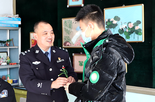 图8，一位“特殊天使”将手工艺花送给刘军，祝警察节快乐！