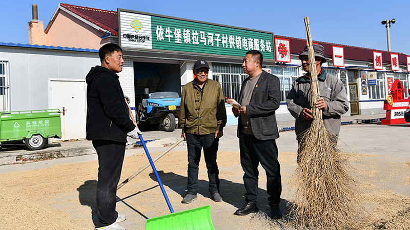 佟磊（右二）为村民普法